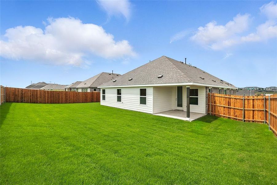 Rear view of house with a patio, a fenced backyard, and roof with shingles