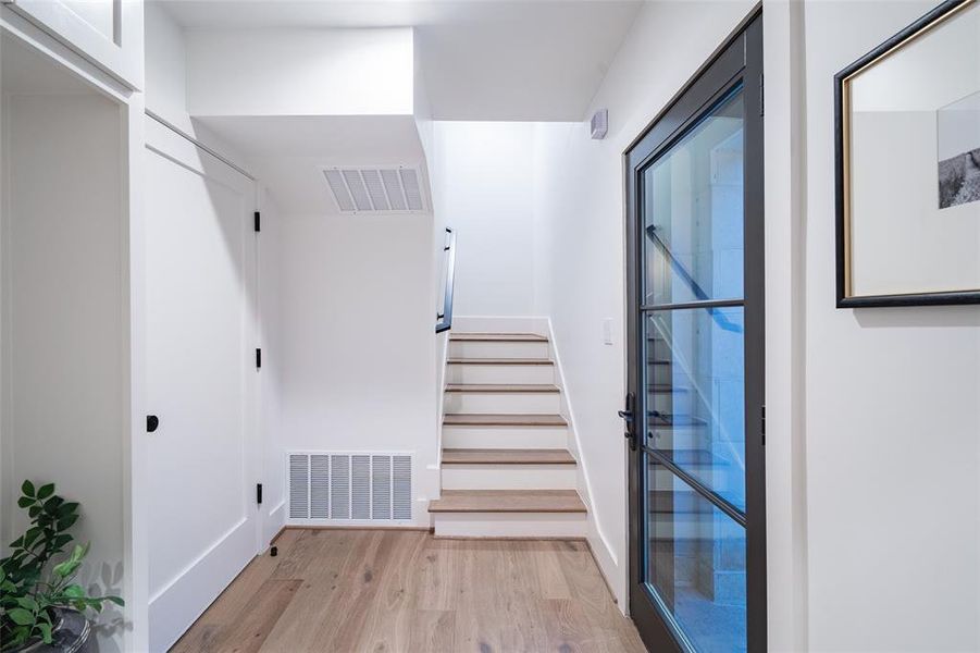 Stairs featuring wood-type flooring