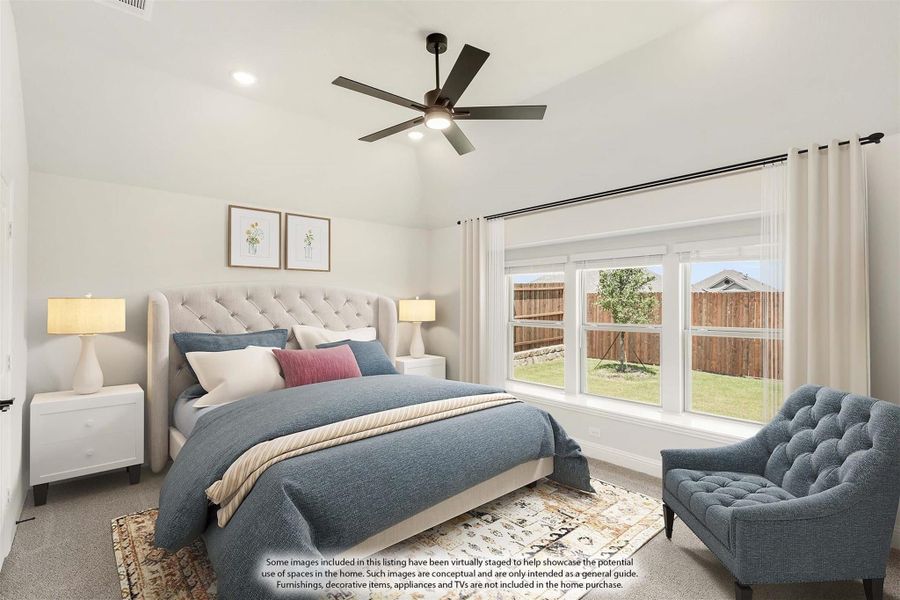 Bedroom with vaulted ceiling, ceiling fan, large windows, and carpeted floor with upholstered bed and accent chair Bedroom with vaulted ceiling, ceiling fan, large windows, and carpeted floor with upholstered bed and accent chair