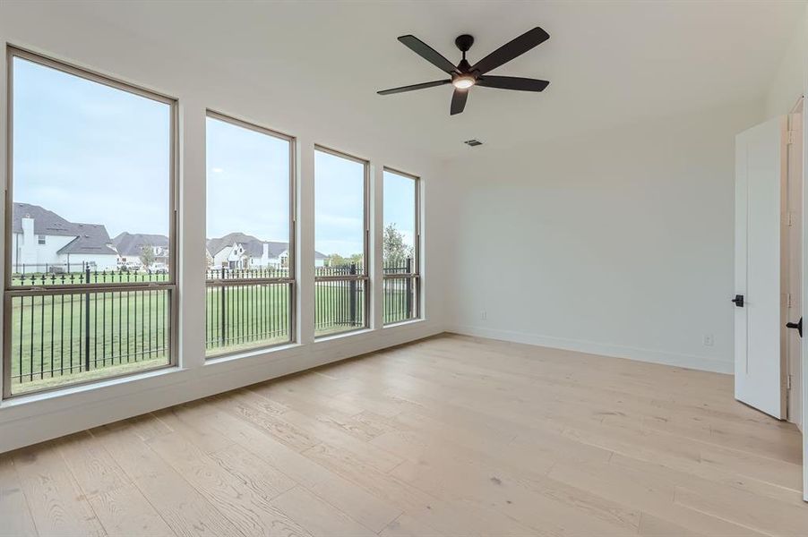 Unfurnished room featuring ceiling fan and light hardwood / wood-style flooring