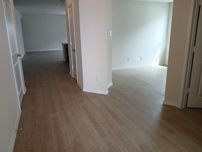 Light wood-finish flooring throughout, complemented by white baseboards and neutral wall tones Light wood-finish flooring throughout, complemented by white baseboards and neutral wall tones