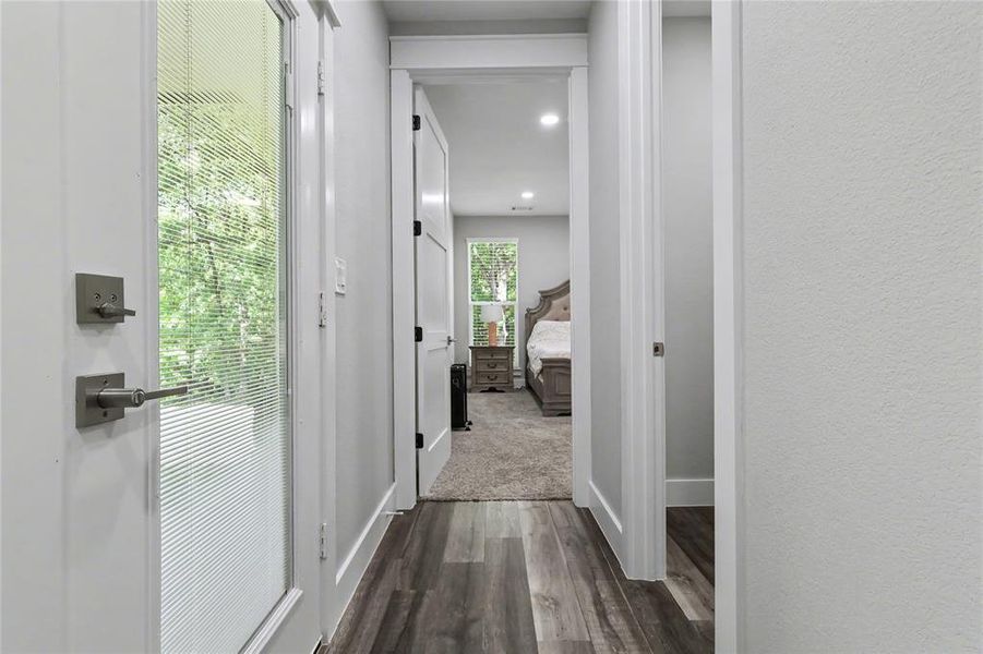 Wood-finish flooring throughout the hallway