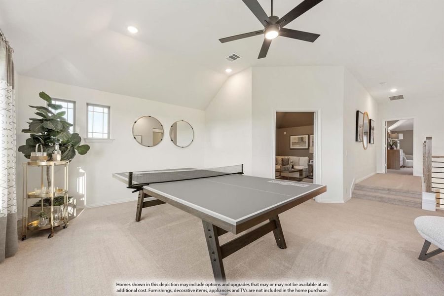 Bonus room with ping pong table, vaulted ceiling, ceiling fan, and carpet flooring Bonus room with ping pong table, vaulted ceiling, ceiling fan, and carpet flooring