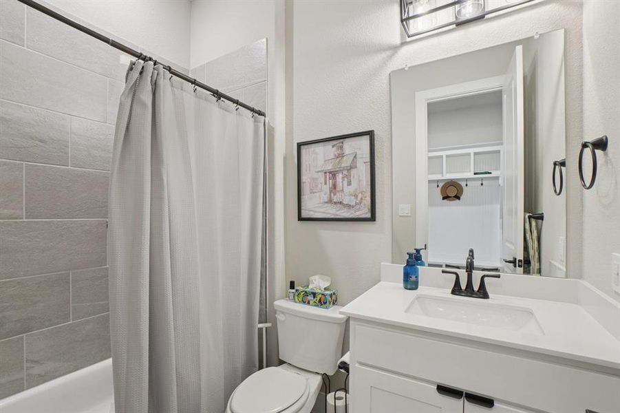 Full bathroom featuring vanity, shower/tub combo.