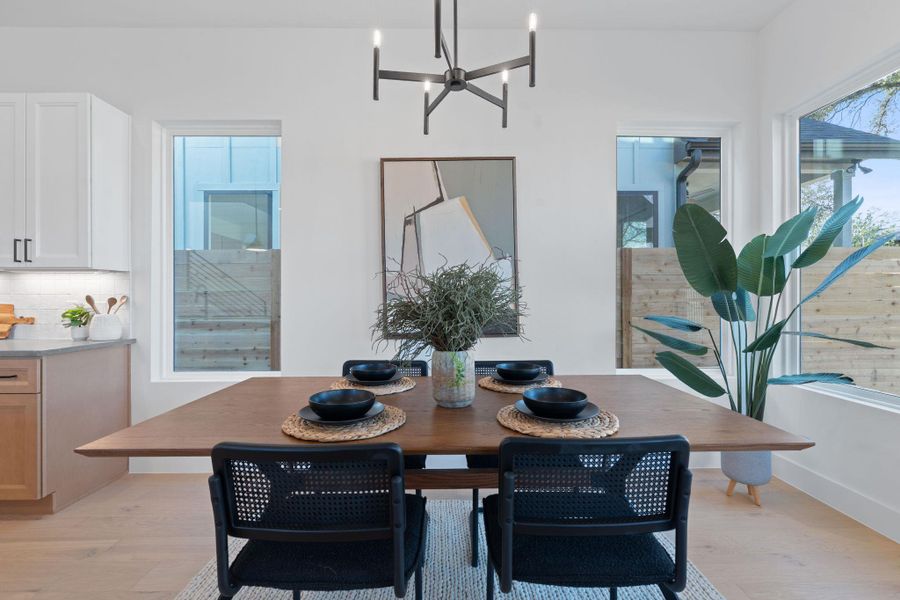 Dining space featuring a chandelier and light wood-style flooring