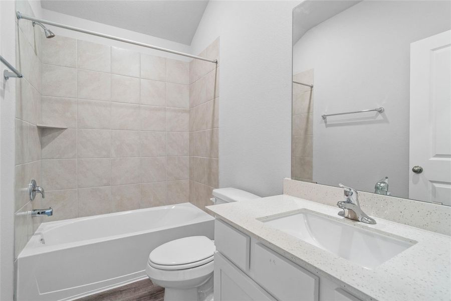 A streamlined secondary bathroom providing a functional tub/shower combination and modern fixtures, seamlessly blending practicality and style.