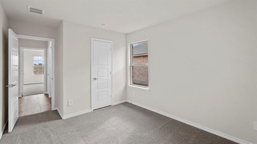 Carpeted room featuring a single window and two panel doors
