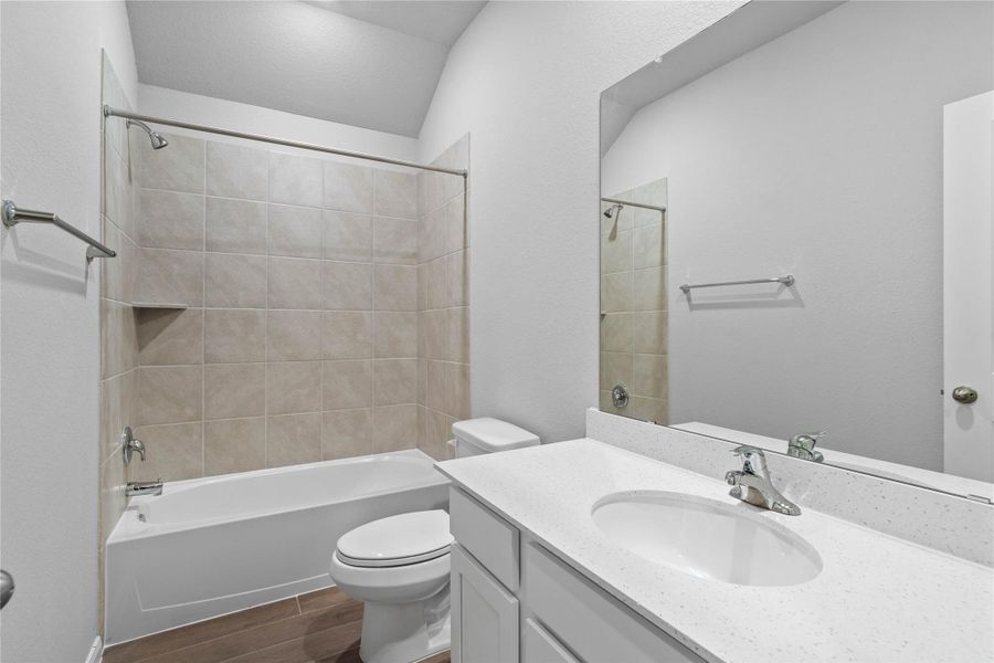 A streamlined secondary bathroom providing a functional tub/shower combination and modern fixtures, seamlessly blending practicality and style.