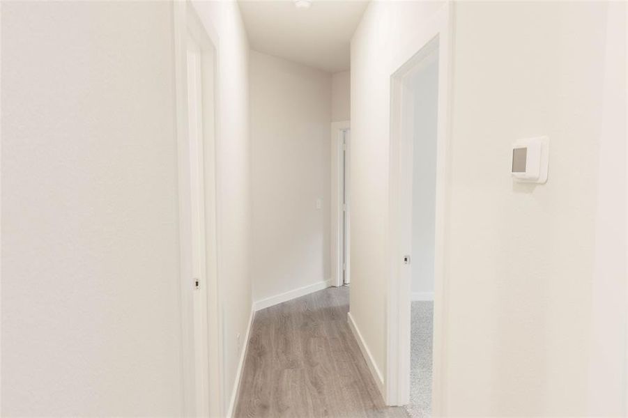 Hallway featuring light hardwood / wood-style flooring