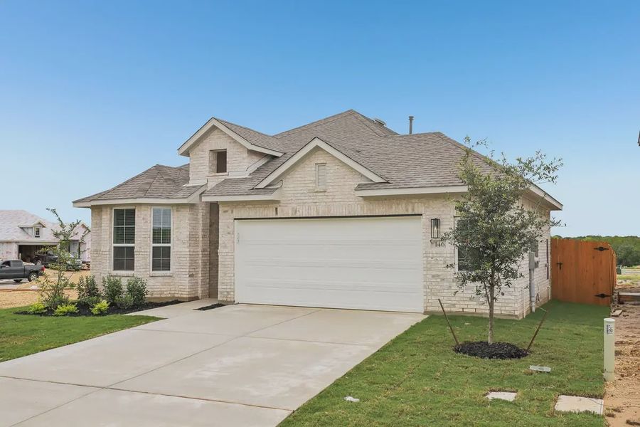Front exterior of a new home in Stream Waters, Seguin, TX, highlighting curb appeal (Image 2). Front exterior of a new home in Stream Waters, Seguin, TX, highlighting curb appeal (Image 2).