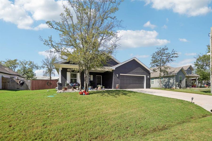 View of front of property with concrete driveway, brick siding, and a garage View of front of property with concrete driveway, brick siding, and a garage