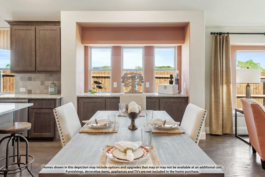 Dining area with gray wood table, white upholstered chairs, and triple windows, open to kitchen with dark brown cabinets Dining area with gray wood table, white upholstered chairs, and triple windows, open to kitchen with dark brown cabinets