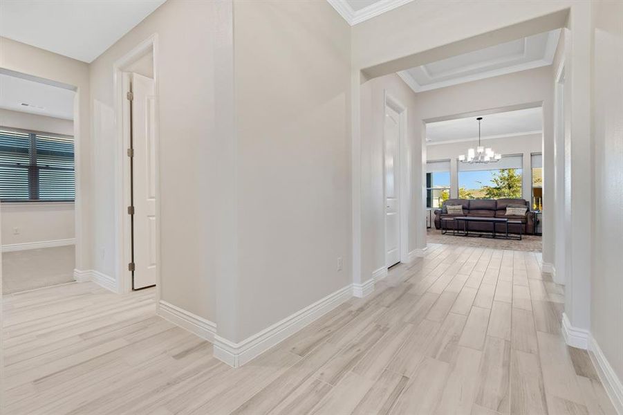 The entry leads onto the left to the guest room.  Straight on leads into the living room, kitchen, and dining room.