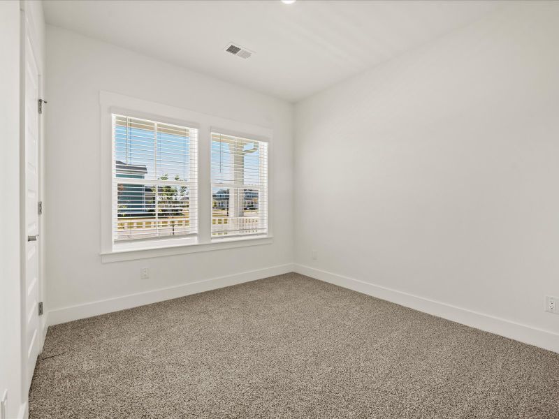 Spacious, unfurnished interior of a new home in The Coves at Lakes of Cane Bay, Summerville (Image 23).