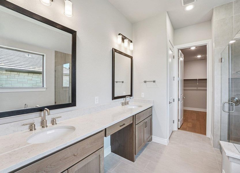 Full bath featuring a shower stall, double vanity, tile patterned floors, a spacious closet, and recessed lighting