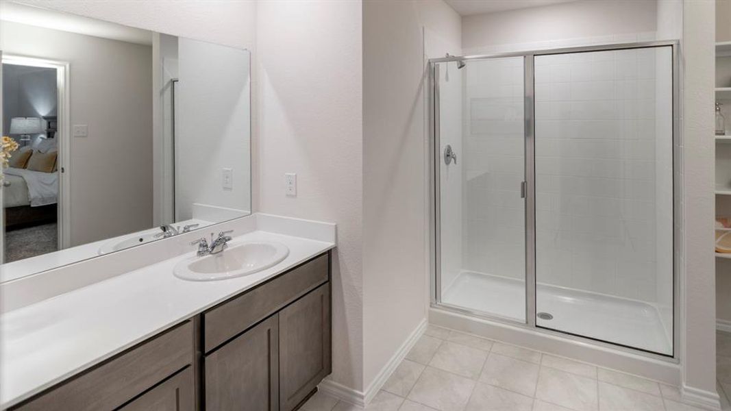 Bathroom with a stall shower, ensuite bath, vanity, and light tile patterned floors