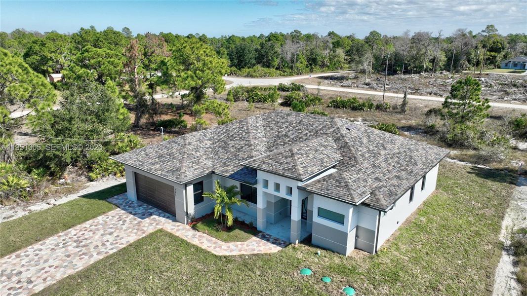 Front exterior of a new home in , Lehigh Acres, FL, highlighting curb appeal (Image 26). Front exterior of a new home in , Lehigh Acres, FL, highlighting curb appeal (Image 26).