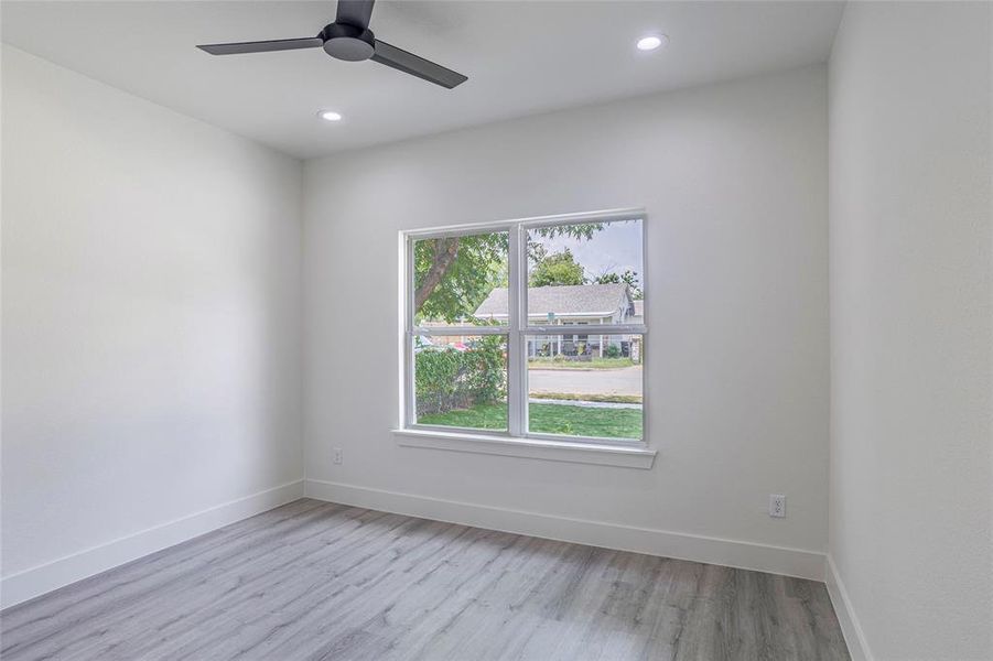 Unfurnished room featuring light wood-type flooring and ceiling fan