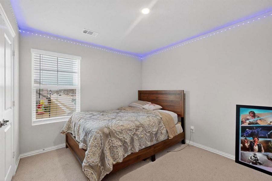 Carpeted bedroom featuring baseboards Carpeted bedroom featuring baseboards