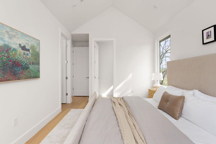 Bedroom featuring wood finished floors and baseboards Bedroom featuring wood finished floors and baseboards