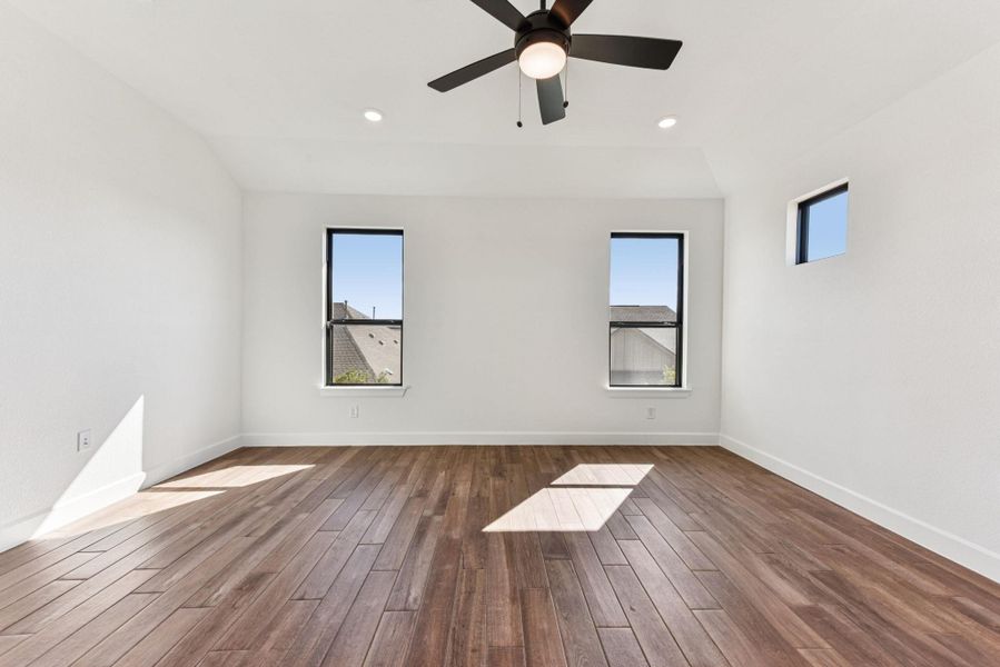 Unfurnished room featuring dark wood-type flooring, recessed lighting, a ceiling fan, and lofted ceiling