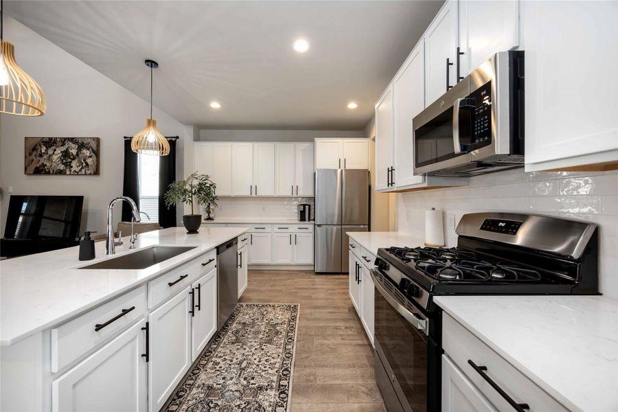 Kitchen with stainless steel appliances and gas cooktop. Kitchen with stainless steel appliances and gas cooktop.