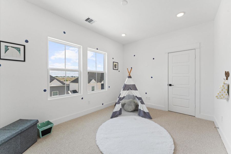 Perched on the third floor for added privacy, this secondary bedroom with ensuite bathroom offers a peaceful retreat ideal for guests or multigenerational living. The bedroom features soft natural light, plush carpeting, and a spacious closet, while the ensuite bath includes a sleek vanity, modern fixtures, and a tub-shower combo for everyday convenience.