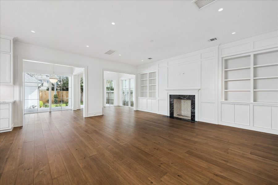 The living room with wood burning fireplace (gas line as well) and built-in shelving. The living room with wood burning fireplace (gas line as well) and built-in shelving.