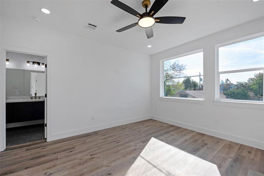 The door to the left from the bedroom leads to the spa-like primary bath.