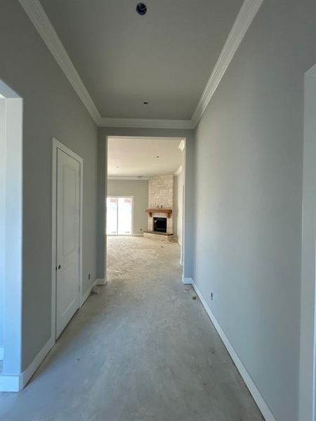 Corridor with concrete floors and crown molding