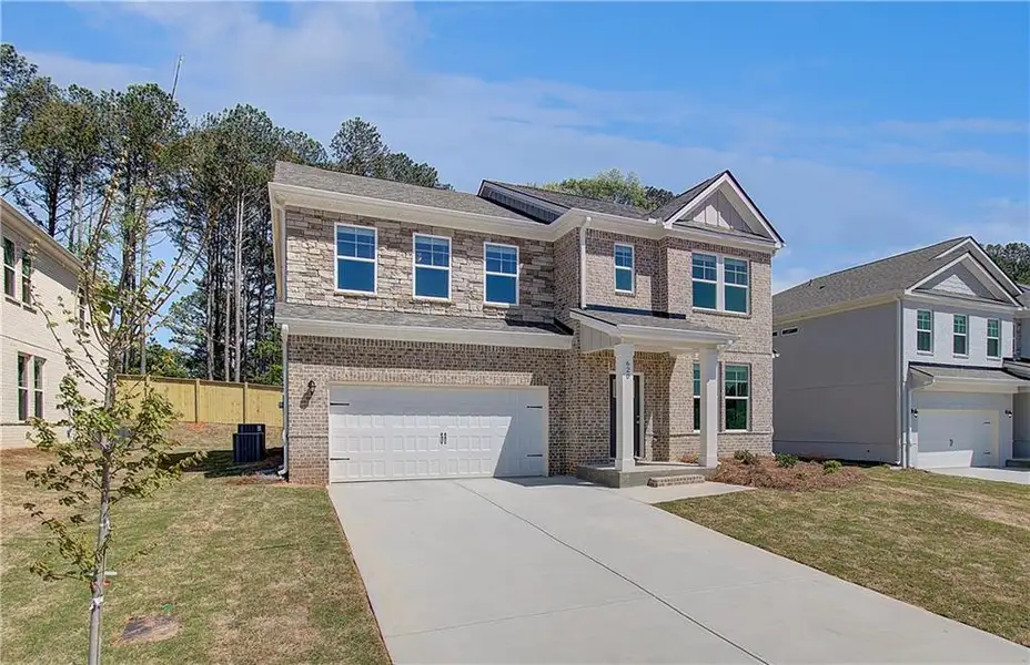 Front exterior of a new home in Bowers Farm, McDonough, GA, highlighting curb appeal (Image 15).