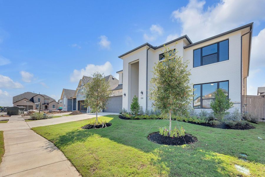 Front exterior of a new home in Flora, Hutto, TX, highlighting curb appeal (Image 26).