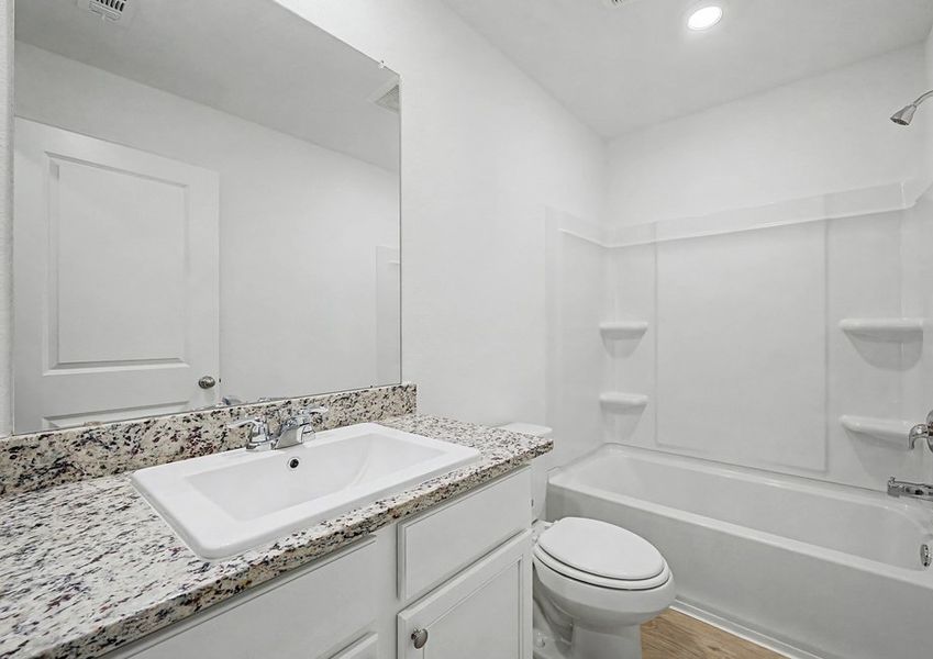 Secondary bathroom with a single-sink vanity and dual shower and tub.
