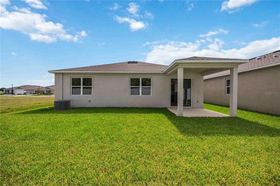Front exterior of a new home in Creekside at Rutland Ranch, Parrish, FL, highlighting curb appeal (Image 2).