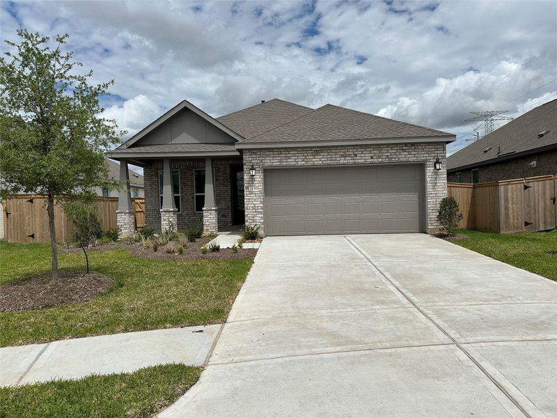 Front exterior of a new home in Windrose Green, Angleton, TX, highlighting curb appeal (Image 1). Front exterior of a new home in Windrose Green, Angleton, TX, highlighting curb appeal (Image 1).