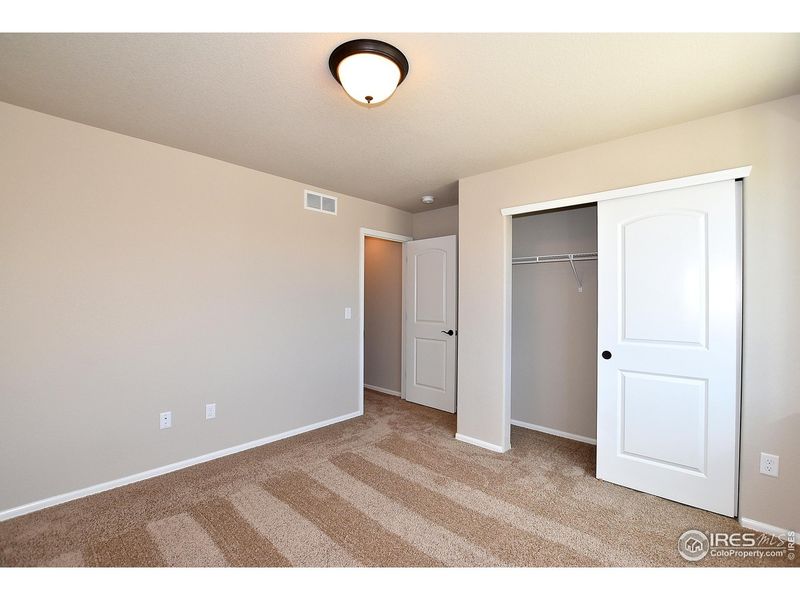 Spacious, unfurnished interior of a new home in Union Colony West, Greeley (Image 32).