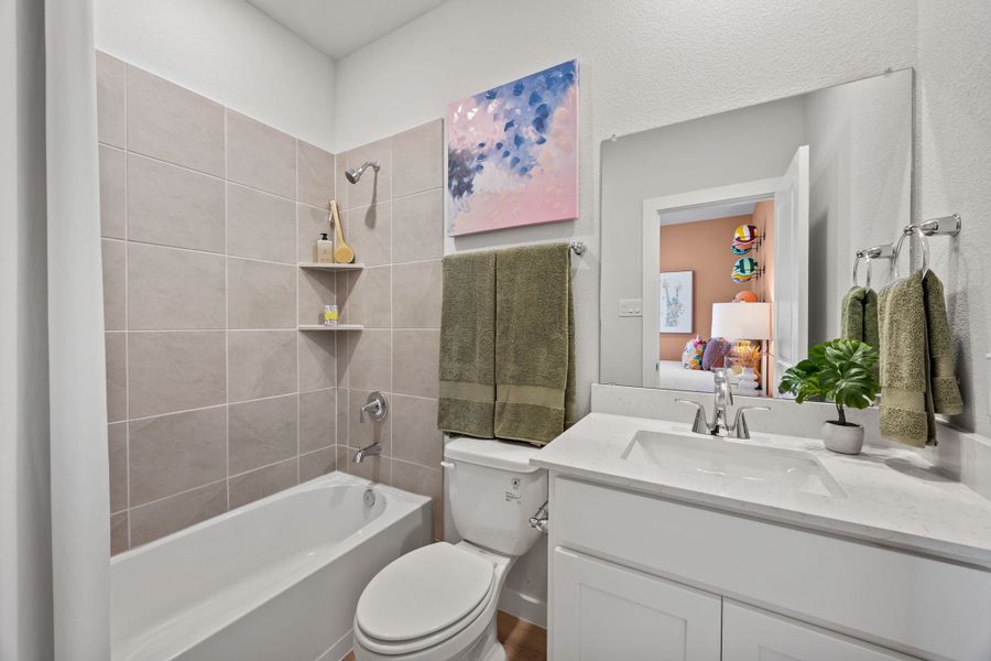 A bathroom with a tub toilet and sink. A bathroom with a tub toilet and sink.