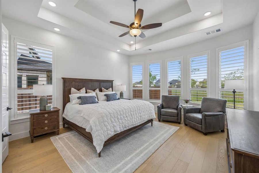 Bedroom featuring light wood-type flooring, a ceiling fan, and recessed lighting