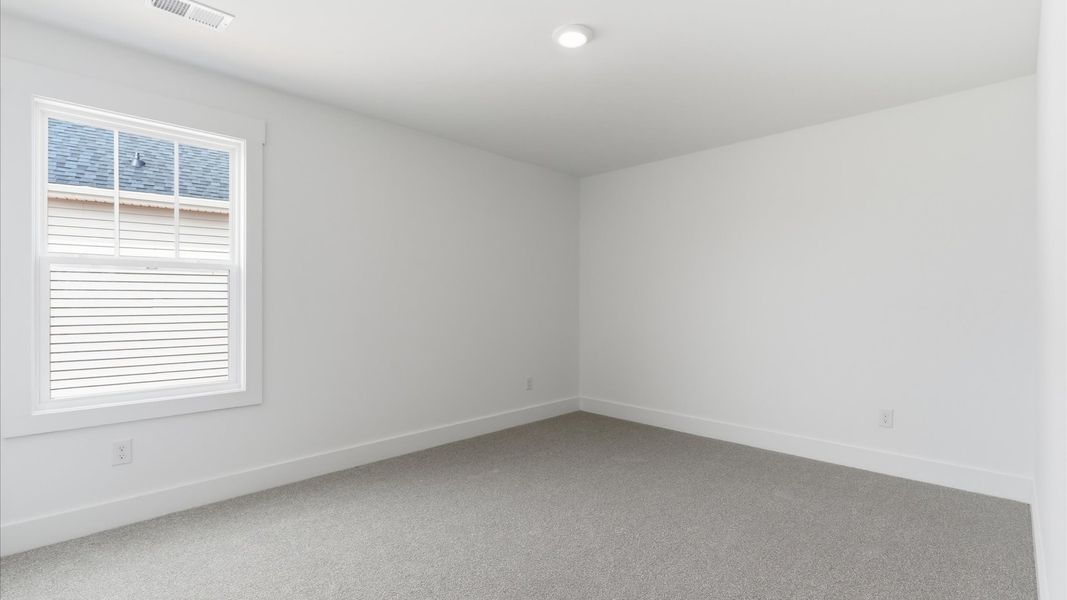 Vibrant and restful bedroom with an oversized window, refined detail, and a warm, welcoming atmosphere in Gray Court, SC