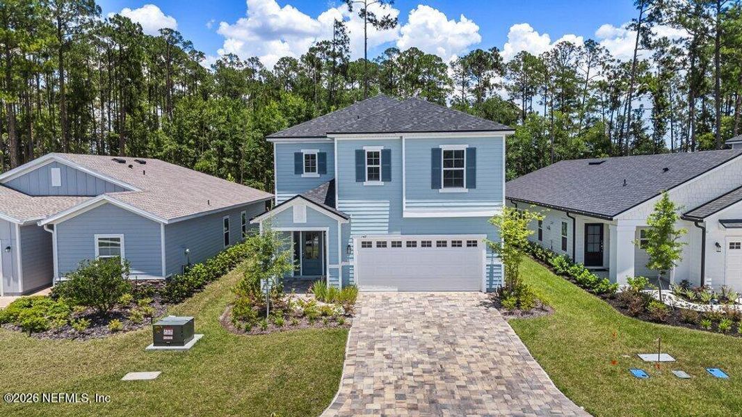 Front exterior of a new home in TrailMark, St. Augustine, FL, highlighting curb appeal (Image 2). Front exterior of a new home in TrailMark, St. Augustine, FL, highlighting curb appeal (Image 2).
