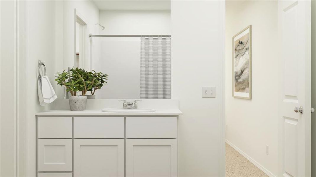 Bathroom featuring curtained shower and vanity