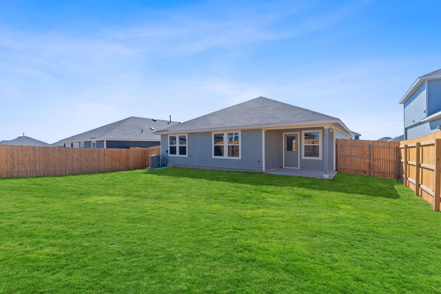 Back of house with a patio area, central AC, a yard, and a fenced backyard