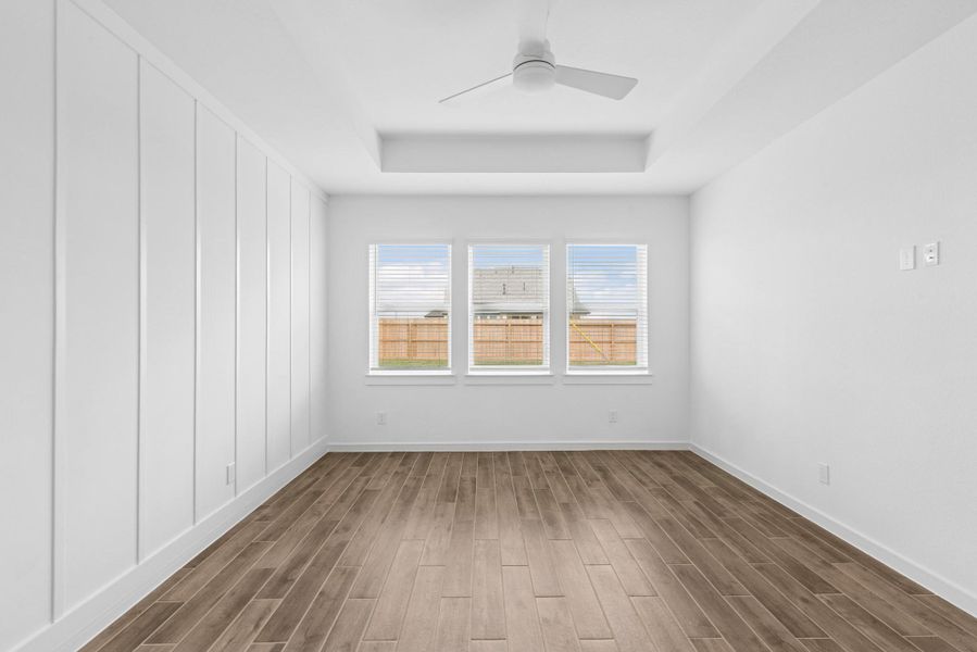 Spacious primary suite with feature wall