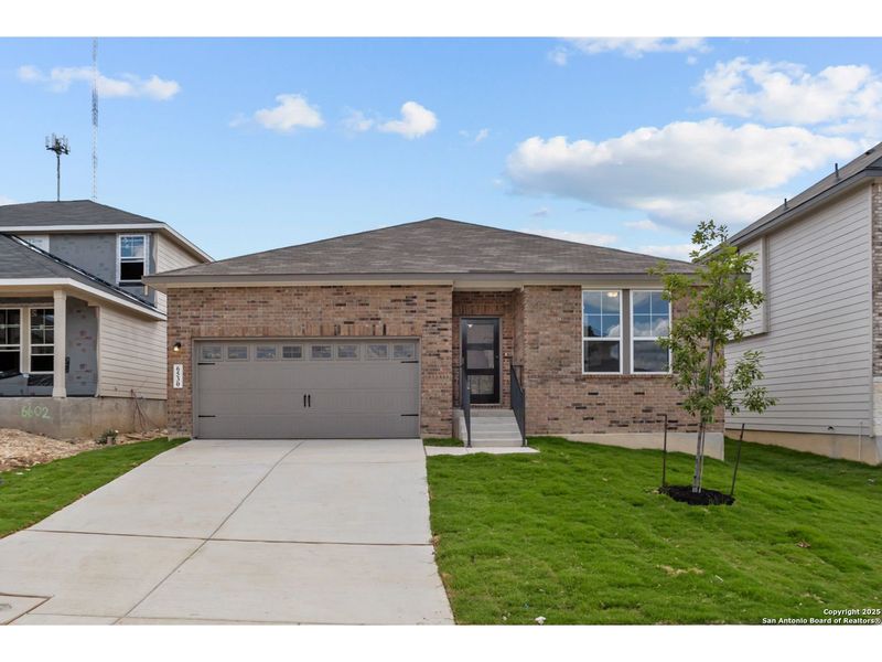 Front exterior of a new home in Royal Crest, San Antonio, TX, highlighting curb appeal (Image 1).