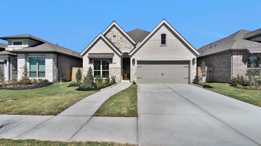 Front exterior of a new home in Valencia, Manvel, TX, highlighting curb appeal (Image 2).