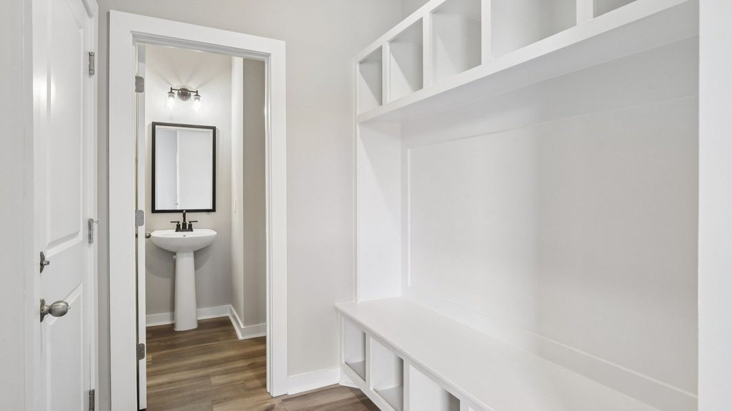 Powder room and built-in drop zone near front entry