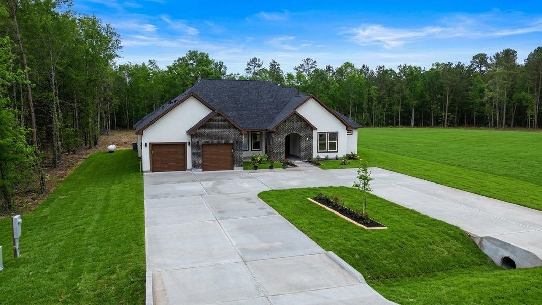 Front exterior of a new home in , Dayton, TX, highlighting curb appeal (Image 21).