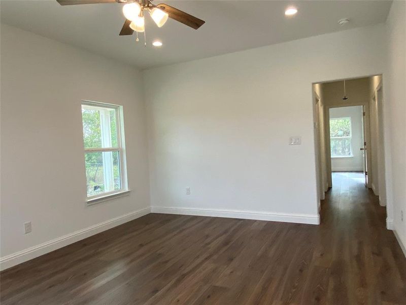 Living room featuring dark wood-type flooring, recessed lighting, and a ceiling fan Living room featuring dark wood-type flooring, recessed lighting, and a ceiling fan
