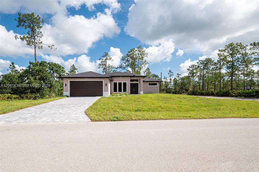 Front exterior of a new home in , Lehigh Acres, FL, highlighting curb appeal (Image 21).