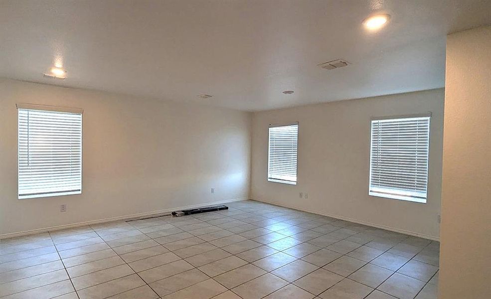 Living room with light tile patterned floors and recessed lighting Living room with light tile patterned floors and recessed lighting